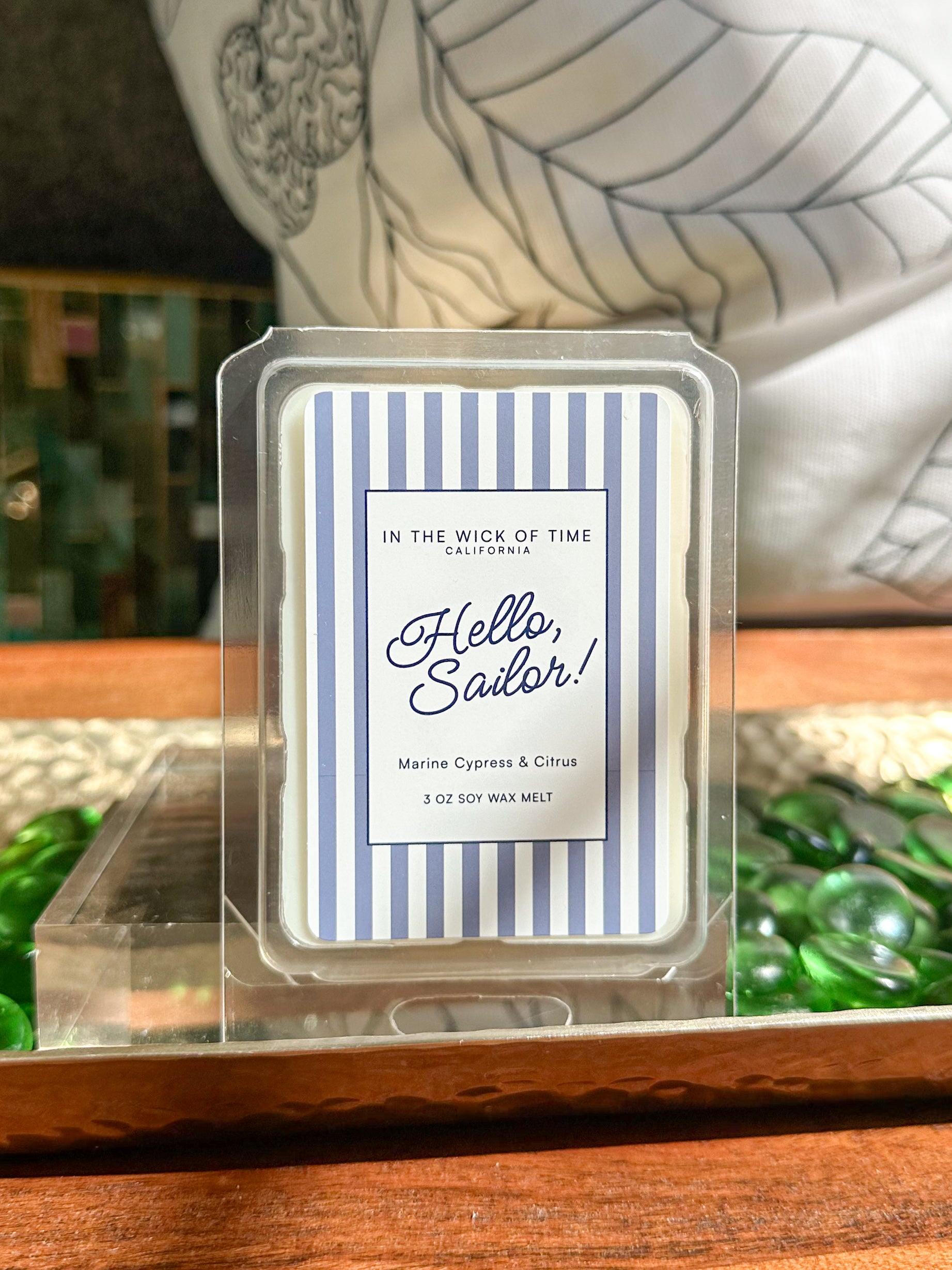 Scented soy wax melt packaging labeled 'Hello, Sailor!” With blue and white stripes 